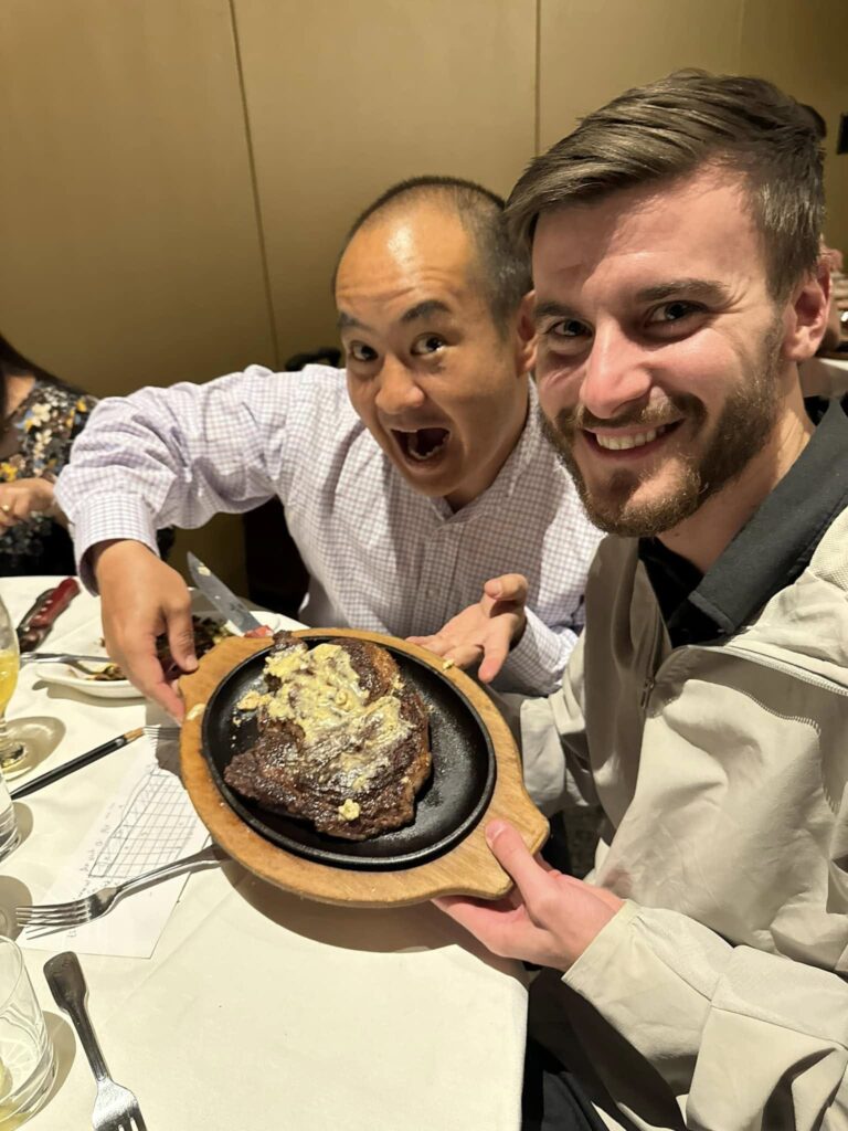 Caleb Guilliams and Dennis Yu at dinner